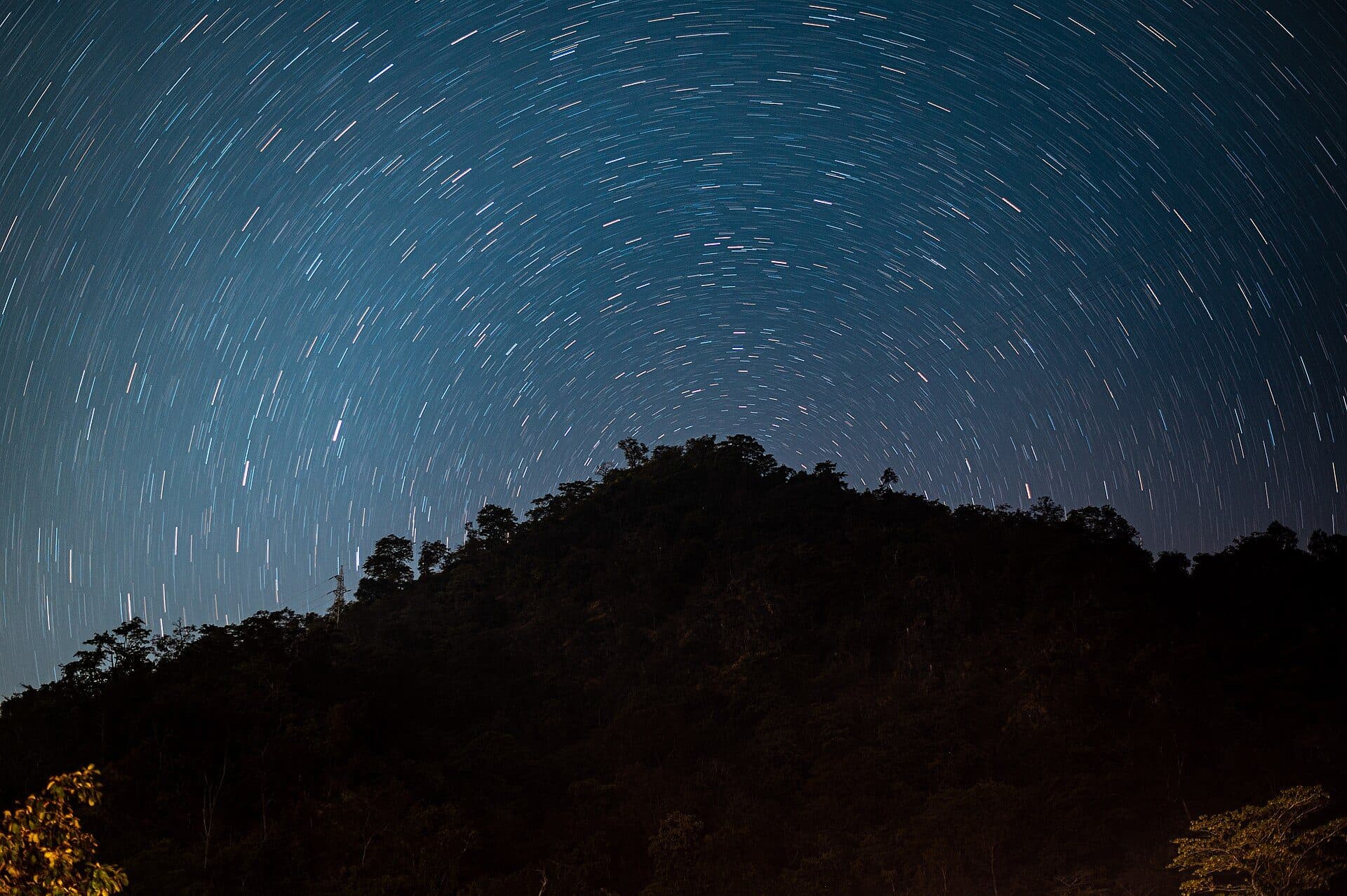 Star trails circling the pole star above the hills near Rishikesh